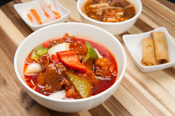Sweet and Sour pork with yellow and green peppers at a Korean restaurant.