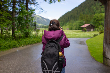 Fototapeta premium Tourist with backpacker take a picture of Switzerland scenery