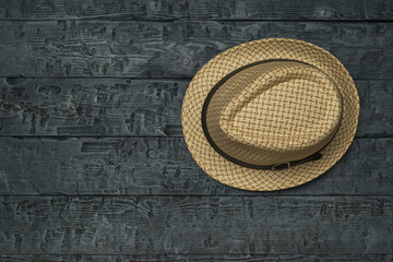 Summer men's hat on a black wooden table.