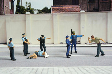 Miniature people of a girl or woman arrested by police and military security officer