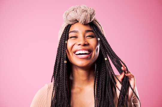 Happy Biracial Woman Posing In Front Of Pink Background