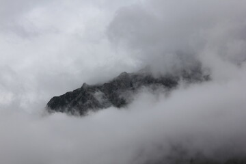 Fototapeta na wymiar The Mountain Peak in Clouds | Cloud Cover Mountain 