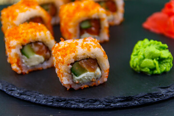 Sushi rolls Philadelphia on a black slate