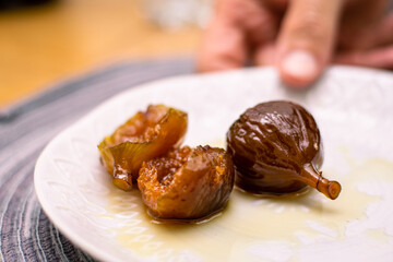 figs in syrup on white plate