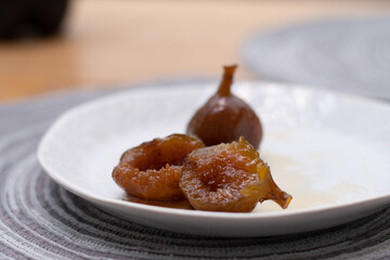 figs in syrup on white plate