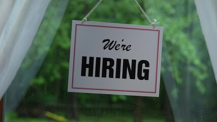 Help Wanted sign on a small business restaurant door.