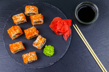 Sushi rolls Philadelphia on a black slate. Top view