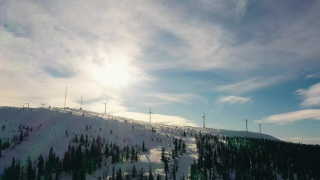 Aerial view of wind turbines on a fell, in Olos, Finland - tracking, drone shot