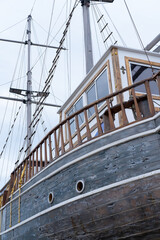 Fototapeta na wymiar wooden sailing old ship and the blue sky behind