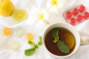 honey lemon herbal healthy drinks health care for cough sore with pastille arrangement flat lay style on background wooden white