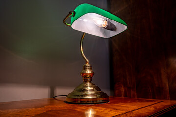 Vintage retro table lamp with green shade and electrical light bulb