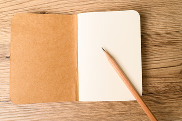 Top view of Open blank notebook on old wood background