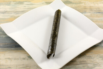 Thai grilled seaweed roll snack on white snack plate on table © merrimonc