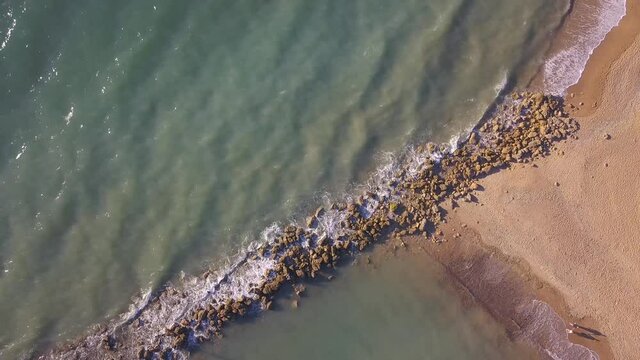 Waves Washing Rocks And Sandy Beach, Espigon de Sancti-Petri In Chiclana de la Frontera, Cadiz, Spain- aerial top down