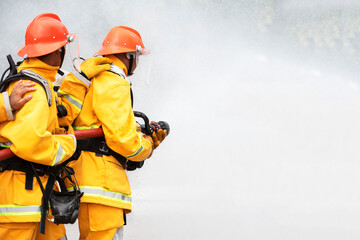 Firefighters train firefighters to use water and fire extinguishers to fight flames in emergency...