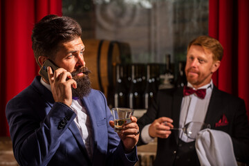 Man at bar. Alcohol beverage. Old traditional whiskey drink. Barman at counter.