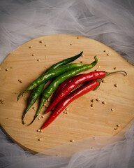 Big red chilli isolated on black background. Chili contains vitamin C, consuming chilies helps prevent intestinal disorders. Chili mockup. Top view. Free copy space.
