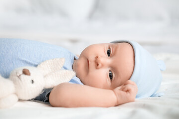 Cute little baby lying on bed at home, closeup