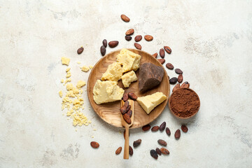 Composition with cocoa butter, powder and beans on light background