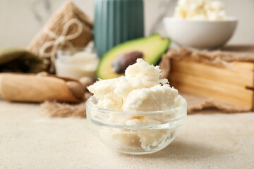 Bowl with shea butter on table