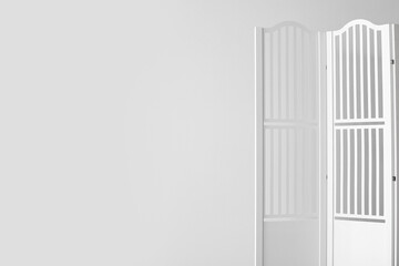 Folding screen near light wall