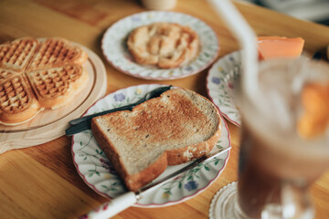 Plate with toasted bread on the wood table. Coffee and dessert concept.