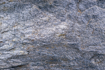 Stone surface for background. Gold-antimony ore. Color - San Juan Hue Blue. Gold streaks.