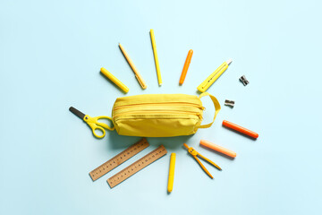 Pencil case and stationery on color background