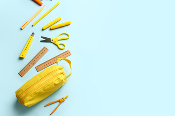 Pencil case and stationery on color background