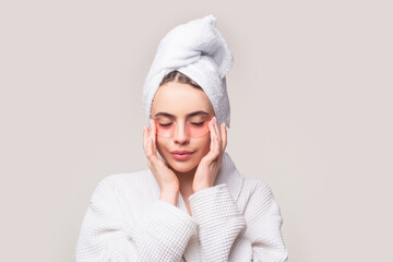 Woman applying eye patches. Close up portrait girl with towel on head. Facial collagen skincare cosmetic. Moisturizing skin. Applying anti-fatigue mask.