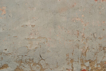 Interior background with texture of old painted concrete wall with peeling plaster.