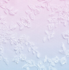 White lwedding lace with decorative embroidery background in blue and pink colors