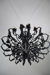 Upward view of a luxury iron chandelier hanging from the ceiling