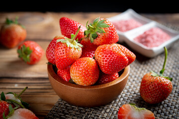 Fresh strawberries in wooden bowl.