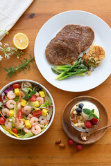 Steaks, salads, desserts and other delicacies on the table