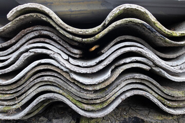 Pile of Old Asbestos cement Roof Sheets. Asbestos in Old Building Materials. Dangerous Building