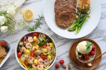 Steaks, salads, desserts and other delicacies on the table