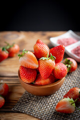 Fresh strawberries in wooden bowl.