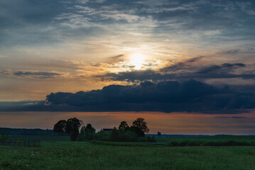 The evening,morning cloud sun and field among trees In the warm summer weather,Nice colored evening summer landscape.