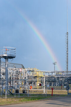 Rainbow is upon gas plant, summer day