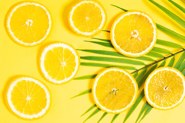 Fototapeta premium Orange slices placed on a yellow background