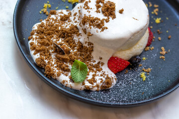 A Soufflé pancake with milk top and strawberry