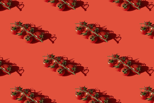 Sprig cherry tomato pattern on red background