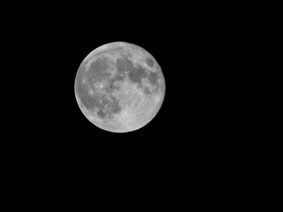 Full moon on dark black sky background