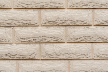 Beige brick wall texture. The exterior wall of a building with dust and dirt.