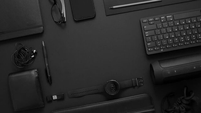 Business concept. Flat lay composition with various black gadgets on dark black surface