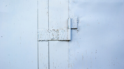 very old metal door with a hinge covered with rust