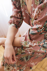 Clothing details and floral dress on the model