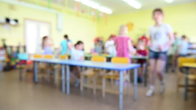 blurred image background children in kindergarten in the afternoon in the group playing. High quality photo