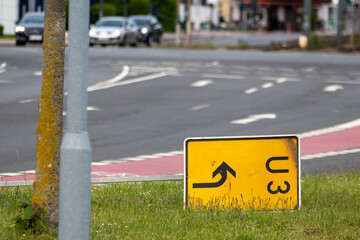 Yellow traffic sign for redirection on urban streets forces navigation system to calculate a new...